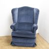 Luxurious navy blue wingback chair, providing comfort and elegance for any living space.