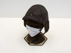 Vintage leather cap with modern face mask, blending nostalgic style and contemporary health awareness.