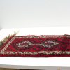 Vibrant red woven rug with intricate diamond patterns, perfect for enhancing any interior space.