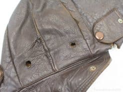 Brown vintage leather jacket with unique wear, textures, and distinctive detailing reflecting its history.