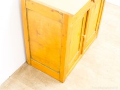 Vintage yellow wooden cabinet, combining rustic charm with practical storage solutions for any home.