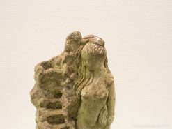 Elegant female sculpture fused with rock, celebrating femininity and nature in earthy tones.