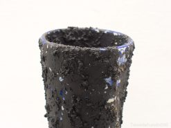 Textured black vase with cobalt blue accents, ideal for modern decor and artistic style.