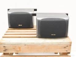 Stylish vintage AKAI speakers on wooden pallet, ideal for audiophiles and design lovers.