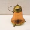 Antique copper bell with brass lid and handle, showcasing vintage elegance and craftsmanship.