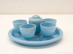 Charming pastel blue tea set with cups and teapot, ideal for cozy gatherings.