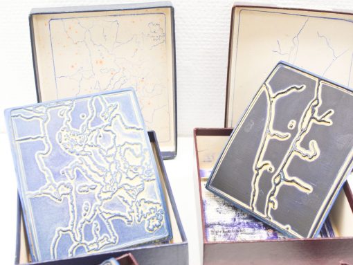 Elegant vintage boxes showcasing intricate ceramic art inspired by nature and abstract designs.