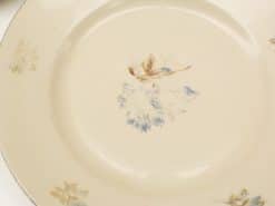 Elegant vintage floral plate in soft cream and blue tones, ideal for dining or decor.