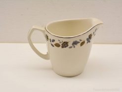 Elegant ceramic pitcher with vintage leaf pattern, perfect for serving or home decor.