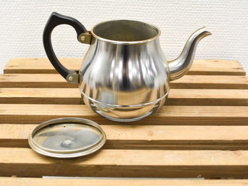 Chic vintage metal teapot with a gleaming finish and ergonomic handle for delightful tea moments.