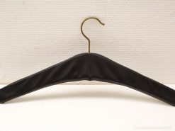 Stylish black vintage hanger with a luxurious metal hook for wrinkle-free garment storage.