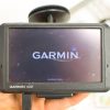 Garmin nüvi GPS device in startup mode, ready for navigation with visible logo and loading maps.