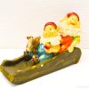 Charming gnome figurine with squirrel on slide, ideal for whimsical garden decor.