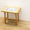 Charming wooden side table with colorful nautical design, ideal for vintage home decor.