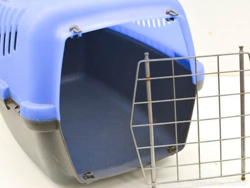 Bright blue and black pet carrier for safe and comfortable transport of small pets.