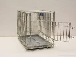 Sturdy metal dog crate with open door and removable tray for safe pet care.