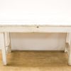 Rustic white table adds vintage charm to any cozy dining space or multifunctional area.