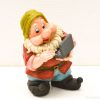 Whimsical gnome figurine with laptop, colorful vintage decor for playful interiors.