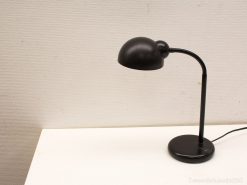 Elegant black desk lamp with a curved arm and dome shade for modern decor.