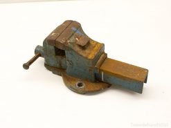 Vintage blue bench vise with character, showing wear and durability for workshop tasks.