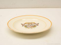 Elegant vintage plate from 1931 featuring floral design and vibrant orange border, perfect for display.