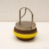 Vintage brown and yellow container with metal lid, perfect for storage and decor.