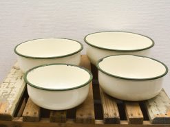 Charming vintage enamel bowls in cream and green, perfect for kitchen use and home decor.