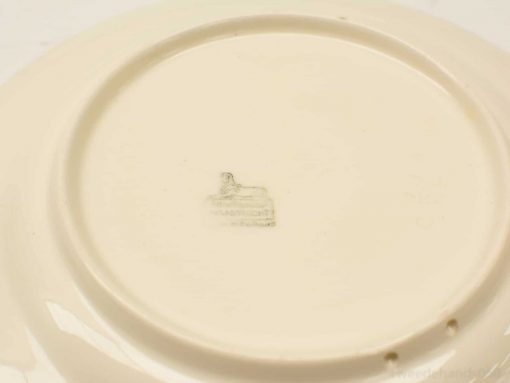 Vintage cream porcelain plate with a glossy finish and faint makers mark, ideal for collectors.