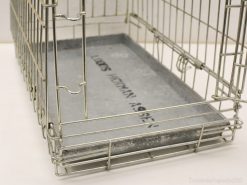 Sturdy vintage metal dog crate with removable tray for easy cleaning and secure pet housing.