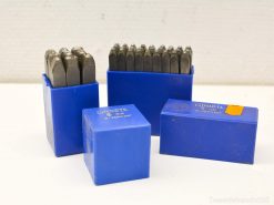 Vintage metal stamping sets in blue cases for precise crafting and organization.