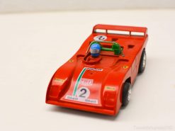 Vibrant red model race car with driver, number 2, perfect for collectors and racing fans.