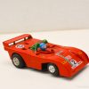 Vibrant red vintage race car model designed for collectors, featuring aerodynamic details and a driver.