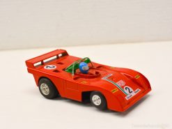 Vibrant red vintage race car model designed for collectors, featuring aerodynamic details and a driver.