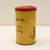 Colorful vintage yellow tin canister with red lid and tropical illustrations, great for decor.