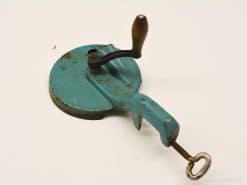 Vintage turquoise kitchen tool with wooden handle, ideal for mixing ingredients and adding charm.