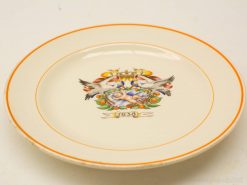 1938 vintage decorative plate featuring a baby with storks and a bright orange border.