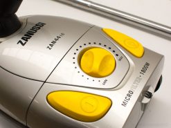 Zanussi ZAN 44.16 vacuum cleaner with modern design, yellow controls, and powerful microfilter system.