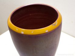 Vintage purple and yellow ceramic vase with unique character and charm for stylish decor.