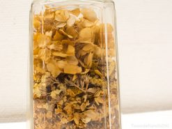 Elegant glass jar filled with dried flowers, showcasing natural beauty and warm earthy tones.