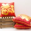 Vibrant red Chinese decorative pillows with golden accents, perfect for festive and cozy interiors.