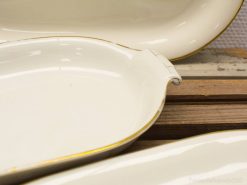 Elegant ceramic dishes with golden edges, perfect for serving or as decorative pieces.