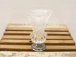 Elegant crystal vase with metallic base, showcasing intricate craftsmanship and timeless design.