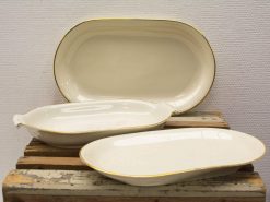 Elegant porcelain serving dishes with golden rims, perfect for festive meals and gatherings.