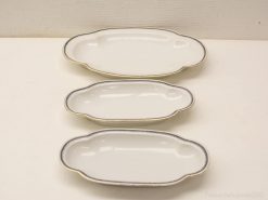 Elegant porcelain serving dishes set for formal occasions, featuring graceful designs and gold accents.