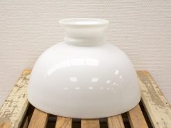 Glossy white ceramic bowl on rustic wood, combining modern elegance with functional charm.