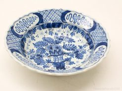 Elegant blue and white ceramic bowl with floral patterns, ideal for decor and collection.