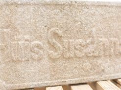 Weathered stone block engraved with Luis Susann, perfect for decor or memorial use.