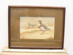 Vibrant ducks in serene watercolor scene, perfect for nature lovers decor.