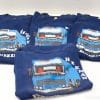 Navy blue Mercedes-Benz truck T-shirts with vibrant graphic design, perfect for automotive enthusiasts.