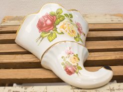 Elegant porcelain wall planter with hand-painted roses and gold rim, perfect for any decor.